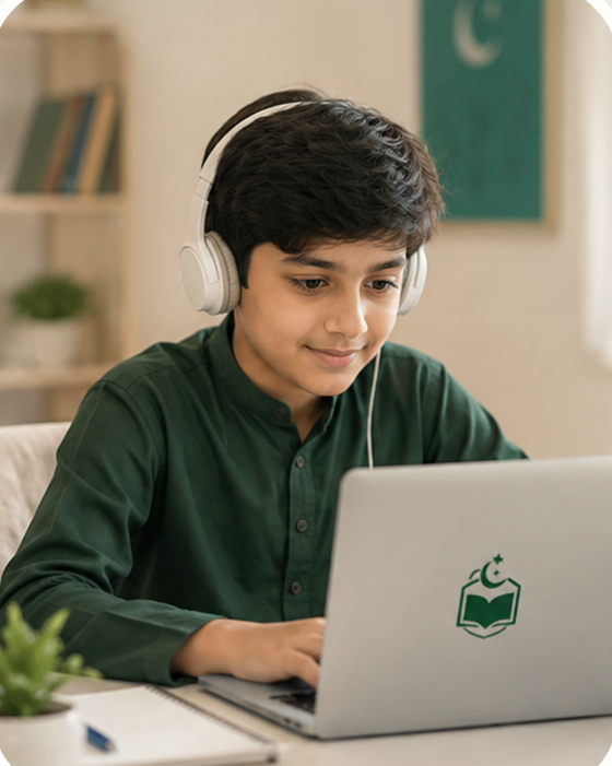 A student writing in a notebook beside his laptop